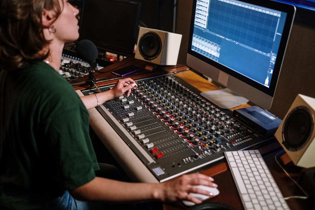Sound engineer adjusting audio levels on a mixing console